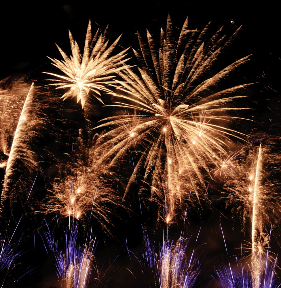 Fireworks extravaganza in reddish-yellow, white, and blue